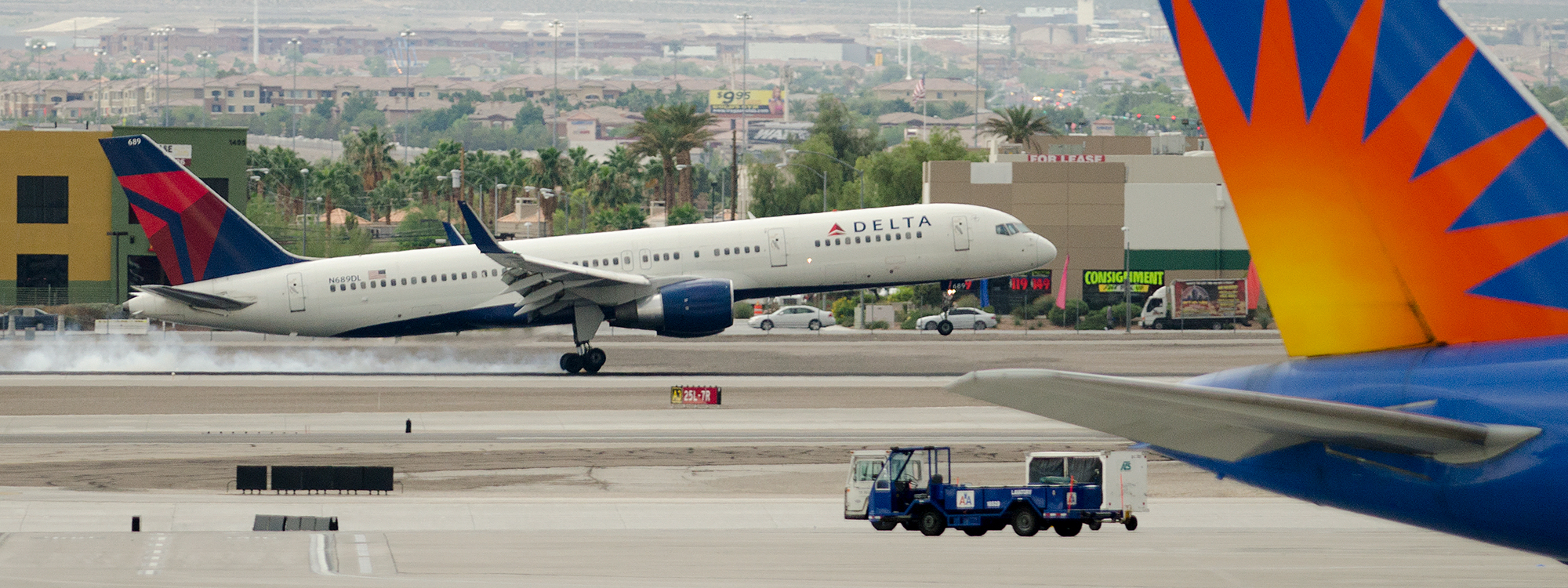 Delta N689DL, a 757-200 touches down on RWY 25R